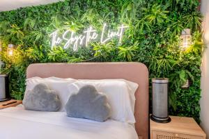 two rocks sitting on a bed in front of a green wall at 1 Bed in Redberth oc-s33669 in Redberth