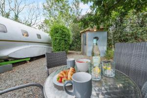 a table with a plate of food and a bottle of wine at 1 Bed in Redberth oc-s33669 in Redberth