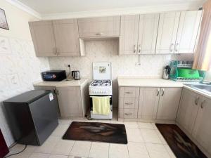a kitchen with white cabinets and a stove top oven at Crystal Luxury Palace in Nairobi