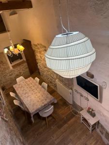 a dining room with a table and a chandelier at El Encantodemora in Mora de Rubielos +12 photos
