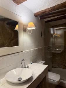 a bathroom with a sink and a toilet at El Encantodemora in Mora de Rubielos