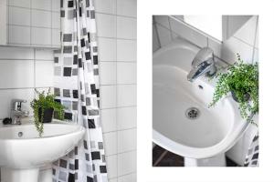 a bathroom with a sink and a bath tub with plants at Cozy Central Studio by the Bus Station in Bergen