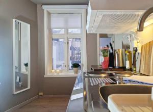 a kitchen with a sink and a window at Cozy Central Studio by the Bus Station in Bergen