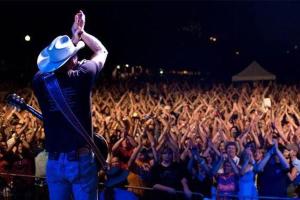 a man standing in front of a crowd of people at Agave Point in Concan +131 photos
