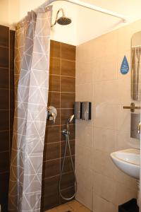 a bathroom with a shower and a sink at Zeit Apartments in Līgatne +69 photos