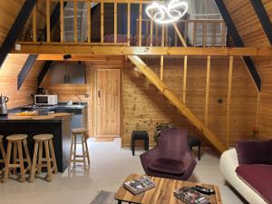 an attic kitchen and living room with wooden walls at Atlasluxuryhome mor in Samsun