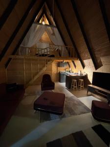 an attic room with a staircase and a living room at Atlasluxuryhome mor in Samsun