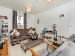 a living room with two couches and a table at One The Loan in Inverness