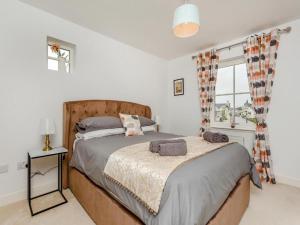a bedroom with a large bed and a window at One The Loan in Inverness