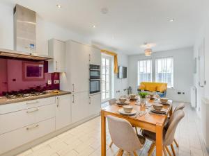 a kitchen with a wooden table and chairs in a room at One The Loan in Inverness