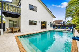 a swimming pool in front of a house at Home in Miami in Lindgren Acres