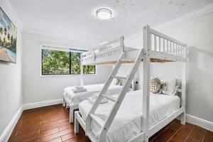 a bedroom with two bunk beds and a window at Home in Miami in Lindgren Acres +34 photos