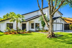 a white house with palm trees in the yard at Home in Miami in Lindgren Acres