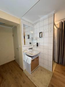 a bathroom with a sink and a mirror at Esos Hotel Quelle in Bad Ragaz +227 photos