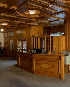 an office with a large wooden desk in a room at PLOSE Parkhotel & Residence in Bressanone