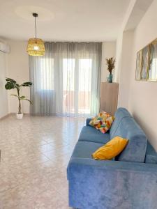 a blue couch in a living room with at Alguer Zizì in Alghero