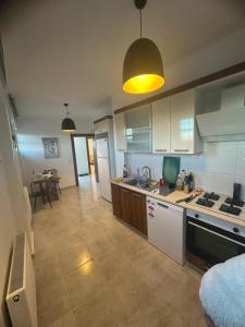 a kitchen with white cabinets and a counter top at Roz Family Mansion 2 in Diyarbakır