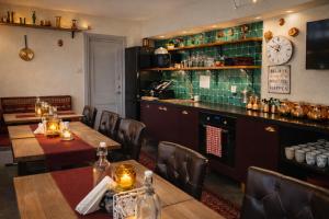 a restaurant with tables and chairs and a bar at Hotel Tre Små Rum in Stockholm +32 photos