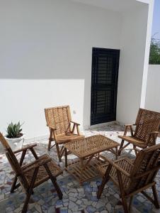 four rattan chairs and a table on a patio at Villa Shérazade in Saint-Louis +14 photos