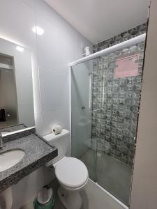 a bathroom with a shower and a toilet and a sink at Pousada Novo Millenium in Araripina