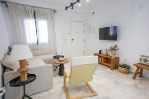 a living room with a couch and a chair at Charming Apartment with Private Terrace in Sanlúcar de Barrameda