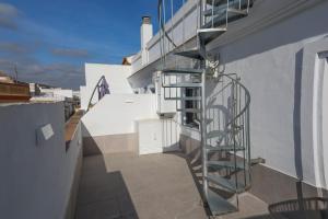 a spiral staircase on the side of a building at Charming Apartment with Private Terrace in Sanlúcar de Barrameda