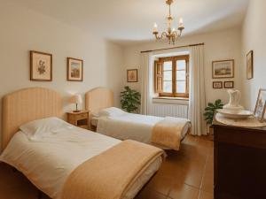 a hotel room with two beds and a window at Masia Can Cenç in Collsuspina +23 photos