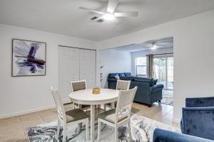 a living room with a table and chairs and a couch at Sun, Sand & Poolside Relaxation! Ormond Beach Unit in Ormond Beach