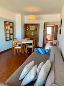 a living room with a couch with pillows on it at Depto Frente Al Mar, Edificio Iskofema II in Miramar +10 photos
