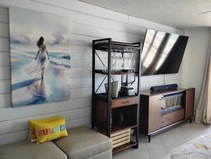 a living room with a picture of a woman on the wall at Daytona Beach Hawaiian Inn in Daytona Beach