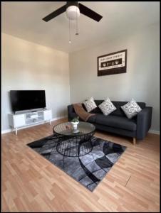 a living room with a couch and a table at Chic City Escape in Berwyn