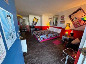 a hotel room with a bed and a living room at Stagecoach 66 Motel by Capital O in Seligman