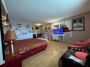 a hotel room with a bed and a tv at Stagecoach 66 Motel by Capital O in Seligman