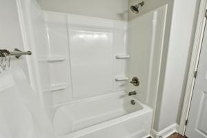 a white bathroom with a tub and a shower at Properties by Preston I 2Bd2bth Townhome in Clarksville +15 photos