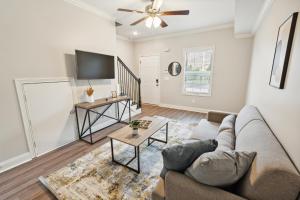 a living room with a couch and a tv at Properties by Preston I 2Bd2bth Townhome in Clarksville
