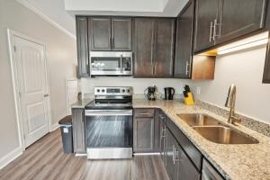 a kitchen with a sink and a stove top oven at Properties by Preston I 2Bd2bth Townhome in Clarksville