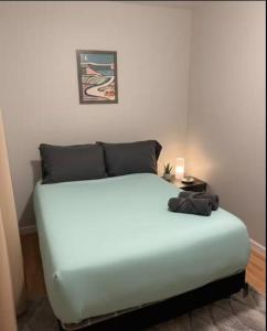 a bedroom with a white bed in a room at Chic City Escape in Berwyn