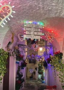 a ceiling with a sign on a building with flowers at n CELI in Uggiano la Chiesa