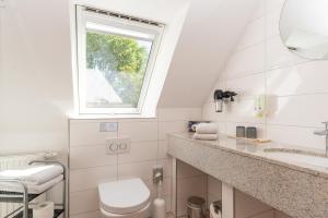 a bathroom with a toilet and a window at Hotel Villa Sonneck-Adults Only in Böhl +86 photos