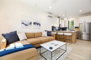 a living room with a couch and a kitchen at Hamilton Place in Traverse City