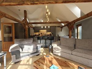 a living room with two couches and a kitchen at 1 Bed in Langmere oc-m33974 in Dickleburgh