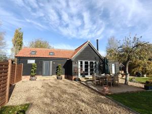a small house with a patio in front of it at 1 Bed in Langmere oc-m33974 in Dickleburgh