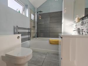 a white bathroom with a toilet and a shower at 1 Bed in Langmere oc-m33974 in Dickleburgh +15 photos