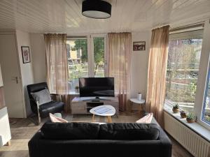a living room with a couch and a table at Hooisma's Erf in Kampen