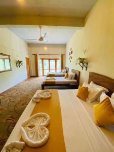 a large room with two beds and a couch at Lushy Glorious Hotel in Matara