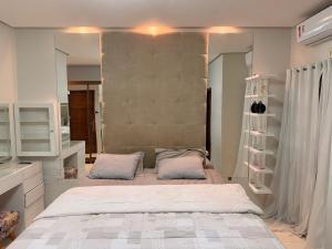 a bedroom with a large bed with two pillows at Casa com piscinas paragominas in Paragominas