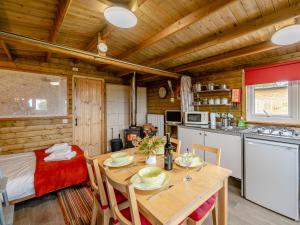 a kitchen and dining room with a table in a cabin at Starling Lodge - Uk31071 in Westward