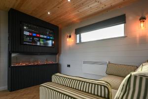 a living room with two couches and a fireplace at Staining Luxury Lodges in Poulton le Fylde