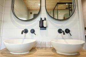 two sinks in a bathroom with two mirrors at Staining Luxury Lodges in Poulton le Fylde +26 photos