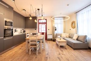 a kitchen and a living room with a couch and a table at Brunova Vila in Plavy